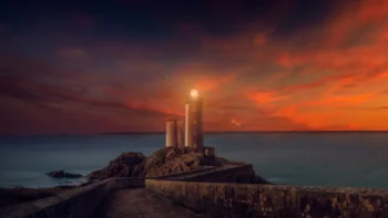 The Kergüen Lighthouse against the backdrop of a blazing sunset in Brittany