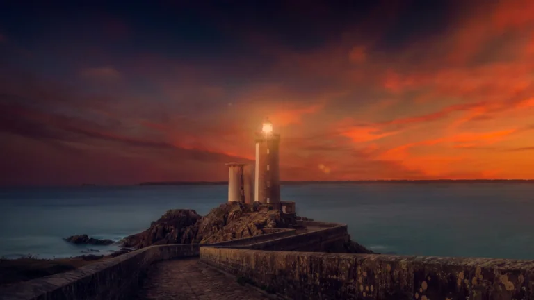 The Kergüen Lighthouse against the backdrop of a blazing sunset in Brittany
