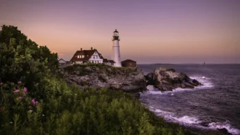 The Portland Head Lighthouse against the backdrop of a twilight sky in Maine