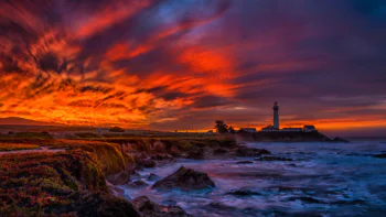 Pigeon Point Lighthouse against the backdrop of a blazing sunset in California