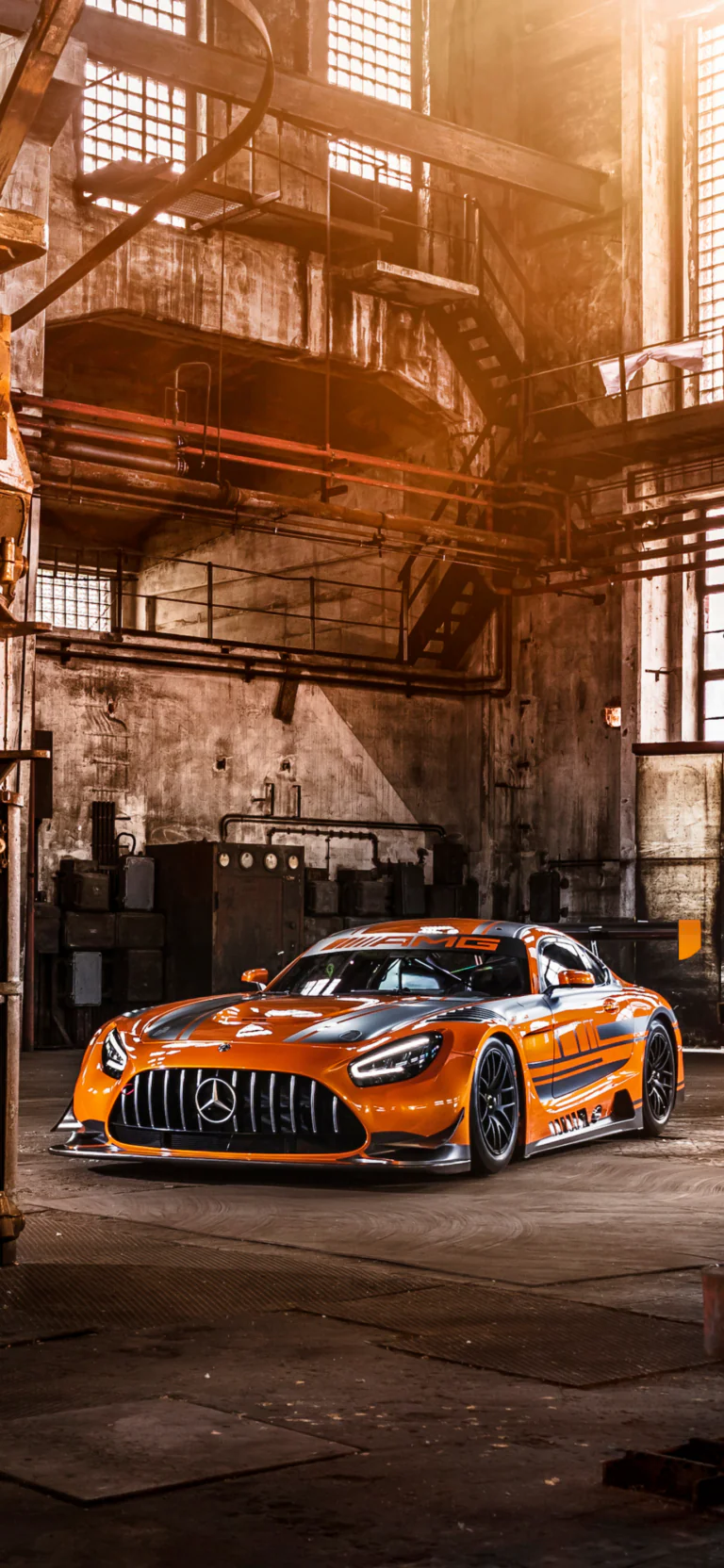 A Mercedes-Benz AMG GT3 inside an abandoned industrial warehouse