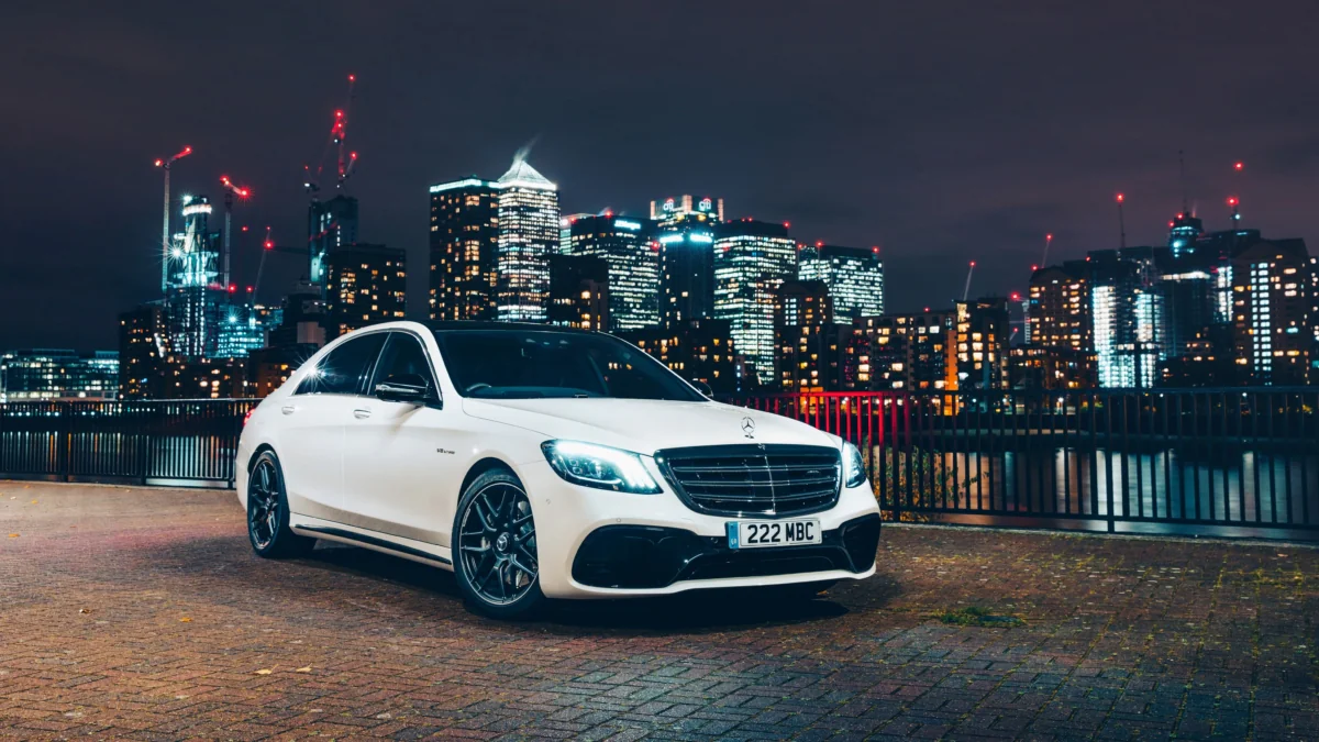 Белый седан Mercedes-Benz S-Class на фоне ночного Лондона