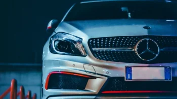 A silver Mercedes-Benz A-Class illuminated by the night lights