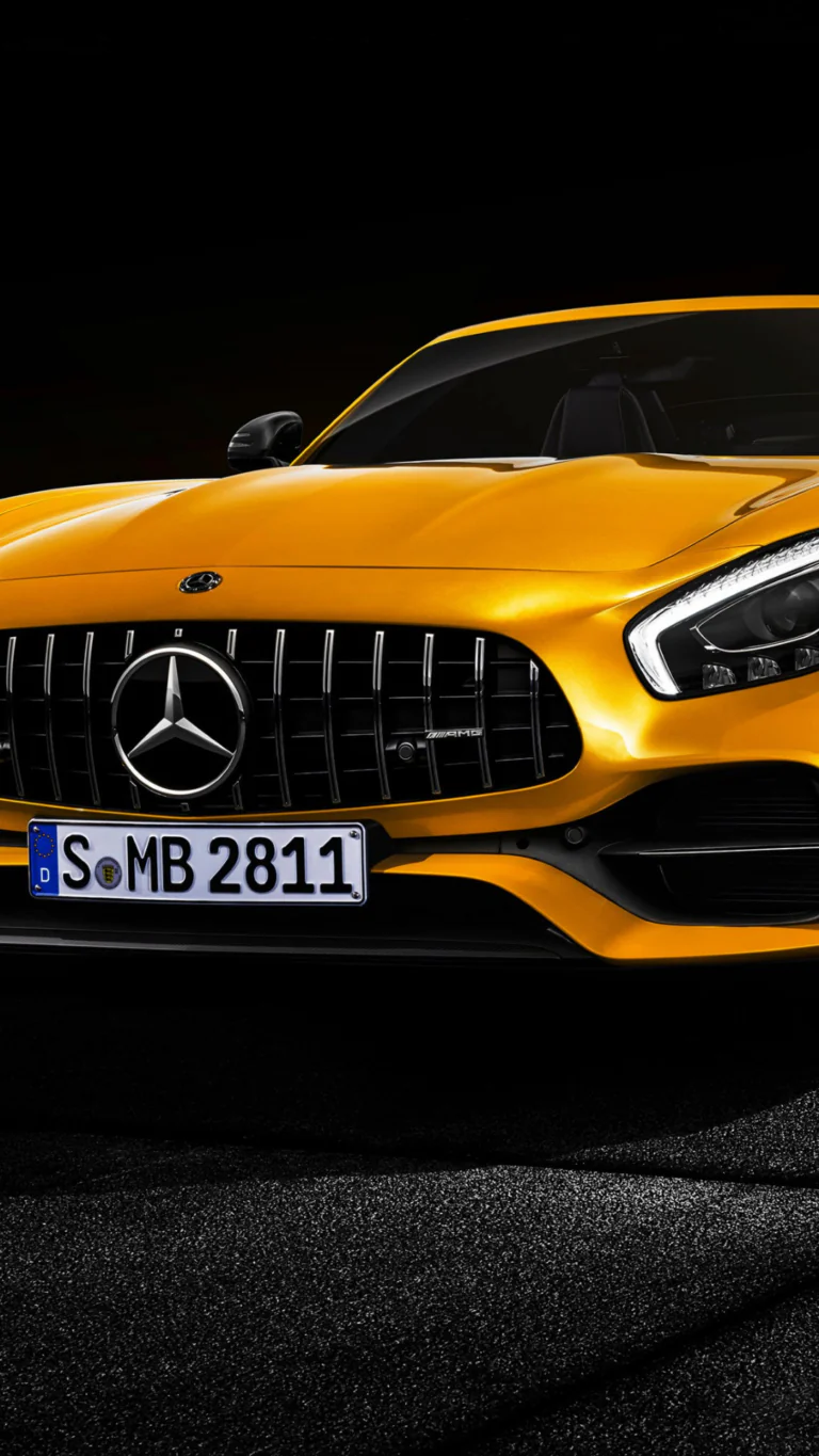 A bright yellow Mercedes-Benz AMG GT against a dark background