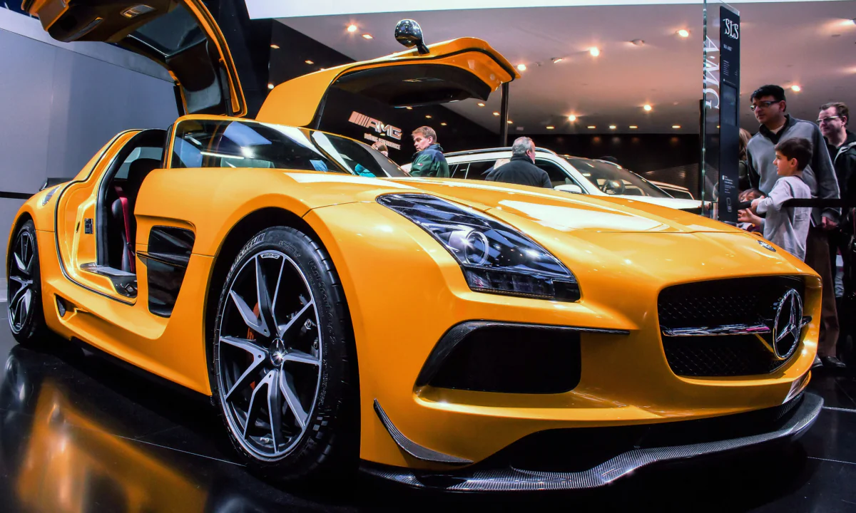 A yellow Mercedes-Benz SLS AMG with its doors open