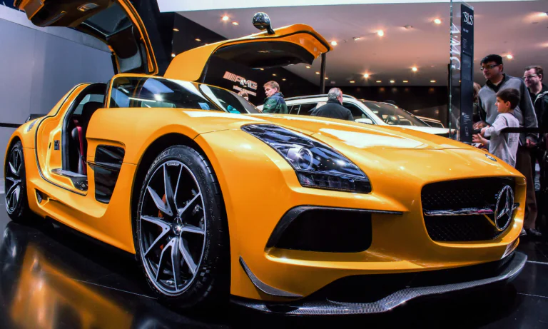 A yellow Mercedes-Benz SLS AMG with its doors open
