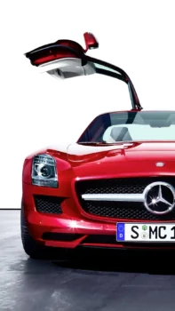 A red Mercedes-Benz SLS AMG with its "gullwing" doors open
