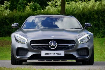 A gray Mercedes-Benz AMG against a backdrop of summer greenery