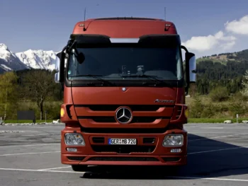 A Mercedes-Benz Actros truck against the backdrop of the snow-covered Alps