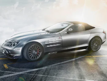 A silver Mercedes-Benz SLR McLaren 722 S on sun-drenched asphalt