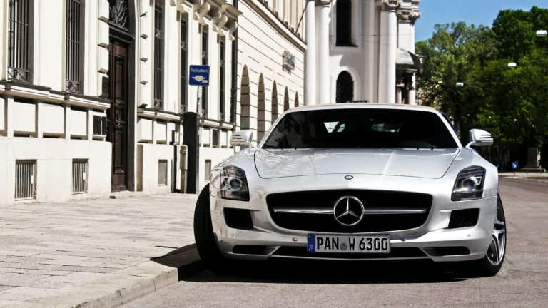 A silver Mercedes-Benz SLS AMG on a quiet European street