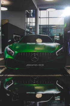 A green Mercedes-Benz AMG GT inside the showroom