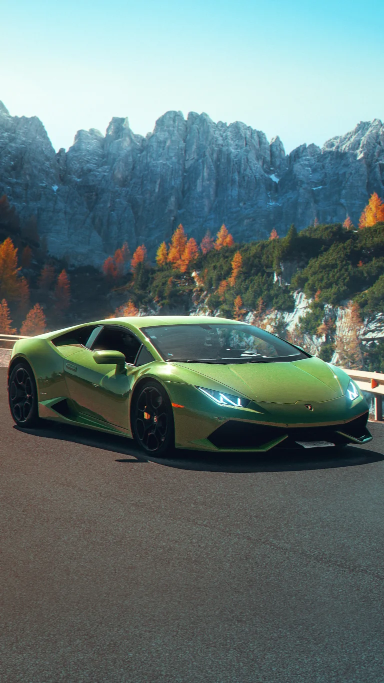 A green Lamborghini Huracán against a backdrop of mountain peaks