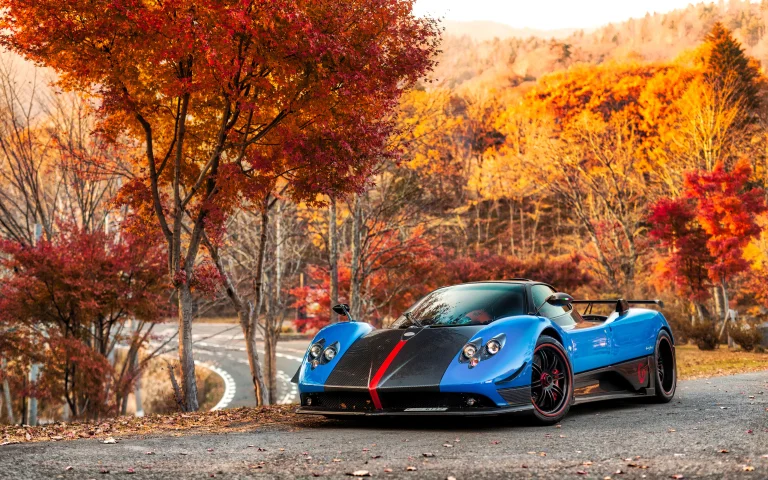 a blue pagani zonda against the backdrop of an autumn forest, pagani zonda, autumn, autumns, cars, automobiles, forest, forests, leaves, foliage, leafage, frondage, pagani, roads, highways, motorways, avenues, driveways, passageways, supercars, hypercars, trees, auto, vehicles