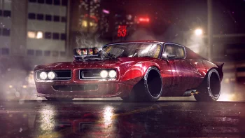 A burgundy Dodge Charger with a powerful engine on a city street at night