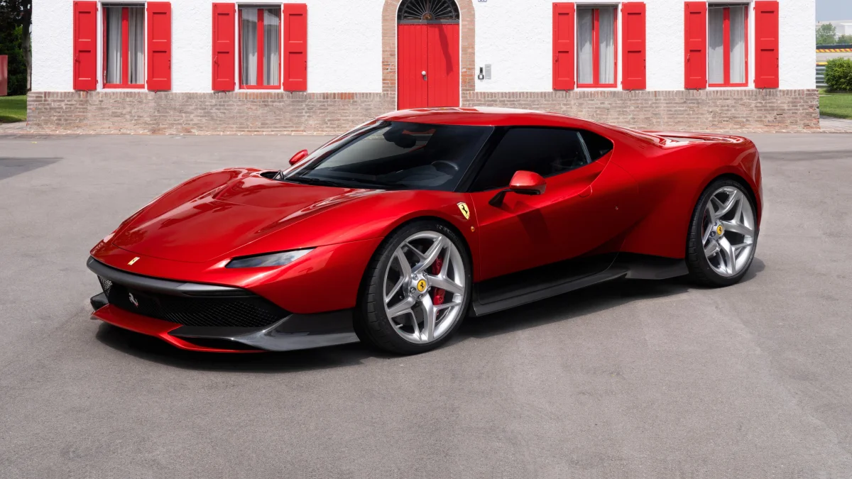A red Ferrari SP48 Unica against the backdrop of an Italian house=