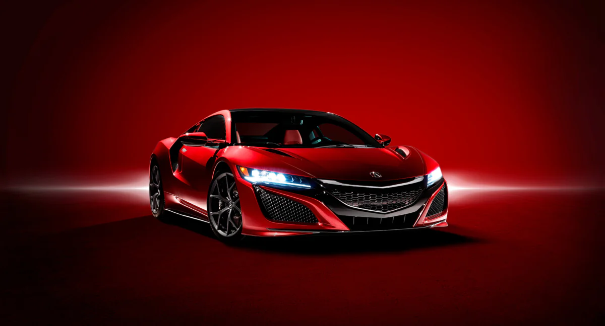Красная Acura NSX в ярком студийном освещении