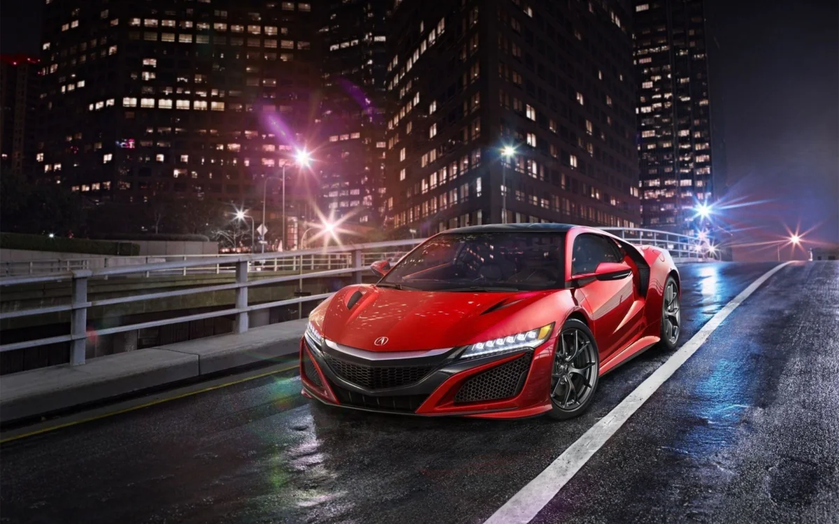 Красная Acura NSX на фоне ночных городских огней