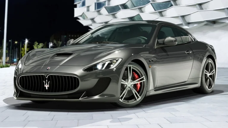 The Maserati GranTurismo in the glow of the night lights