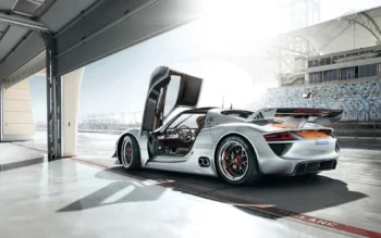 A silver Porsche 918 Spyder in the pits at the racetrack