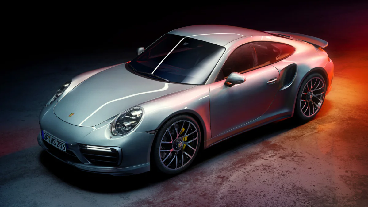 A silver Porsche 911 Turbo under contrasting neon lighting