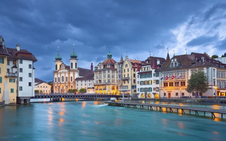 the jesuit church and the reuss river embankment in lucerne, switzerland, lucerne, bridges, churches, cities, city, cityscape, cityscapes, clouds, rivers, canals, streams, waterfronts, marinas, architecture, world