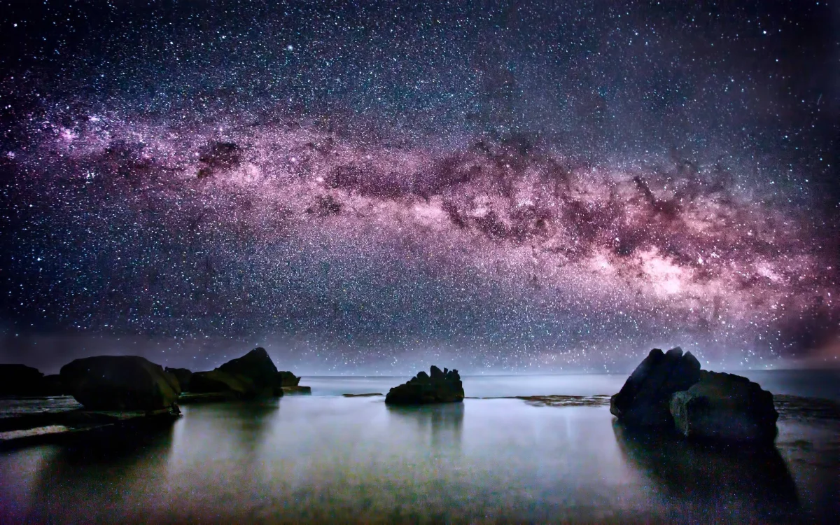 The Milky Way over the calm waters of the ocean