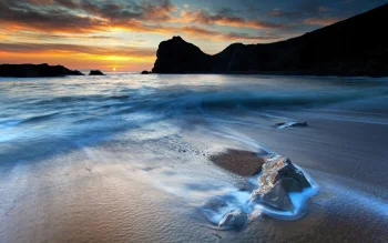 A golden sunset over the wild beach at Durl-Dor