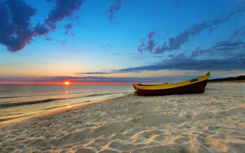 a fishing boat on a sandy shore bathed in the glow of the sunset, beaches, coasts, boats, motorboats, speedboats, evening, evenings, twilight, dus, landscapes, sand, sands, sea, sky, sun, sun rays, sunlight, rays, sunsets, sunset, nature, world