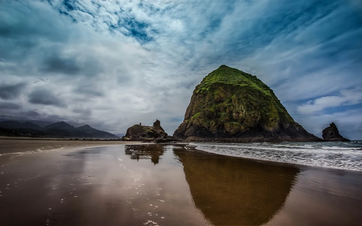 Haystake Rock on Oregon's sandy coast on a cloudy day
