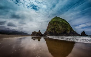 Haystake Rock on Oregon's sandy coast on a cloudy day