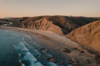 The golden light of sunset over the rocky coast of the Algarve