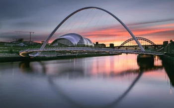 The Gateshead Millennium Bridge and the Tyne Bridge at sunset in the United Kingdom