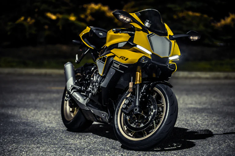 A bright yellow Yamaha YZF-R1 on the asphalt at dusk
