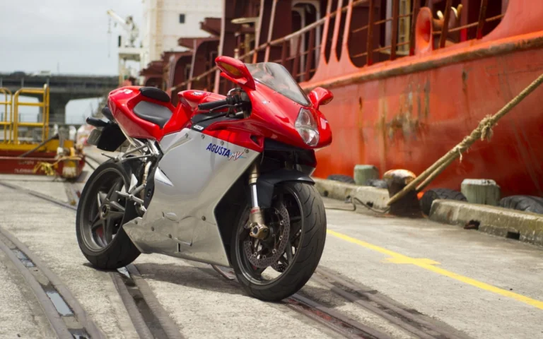 A red MV Agusta F4 against the backdrop of a cargo ship in the harbor