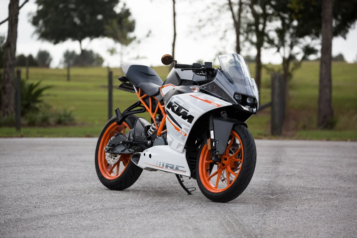 A KTM RC 390 sport bike against the backdrop of a park path