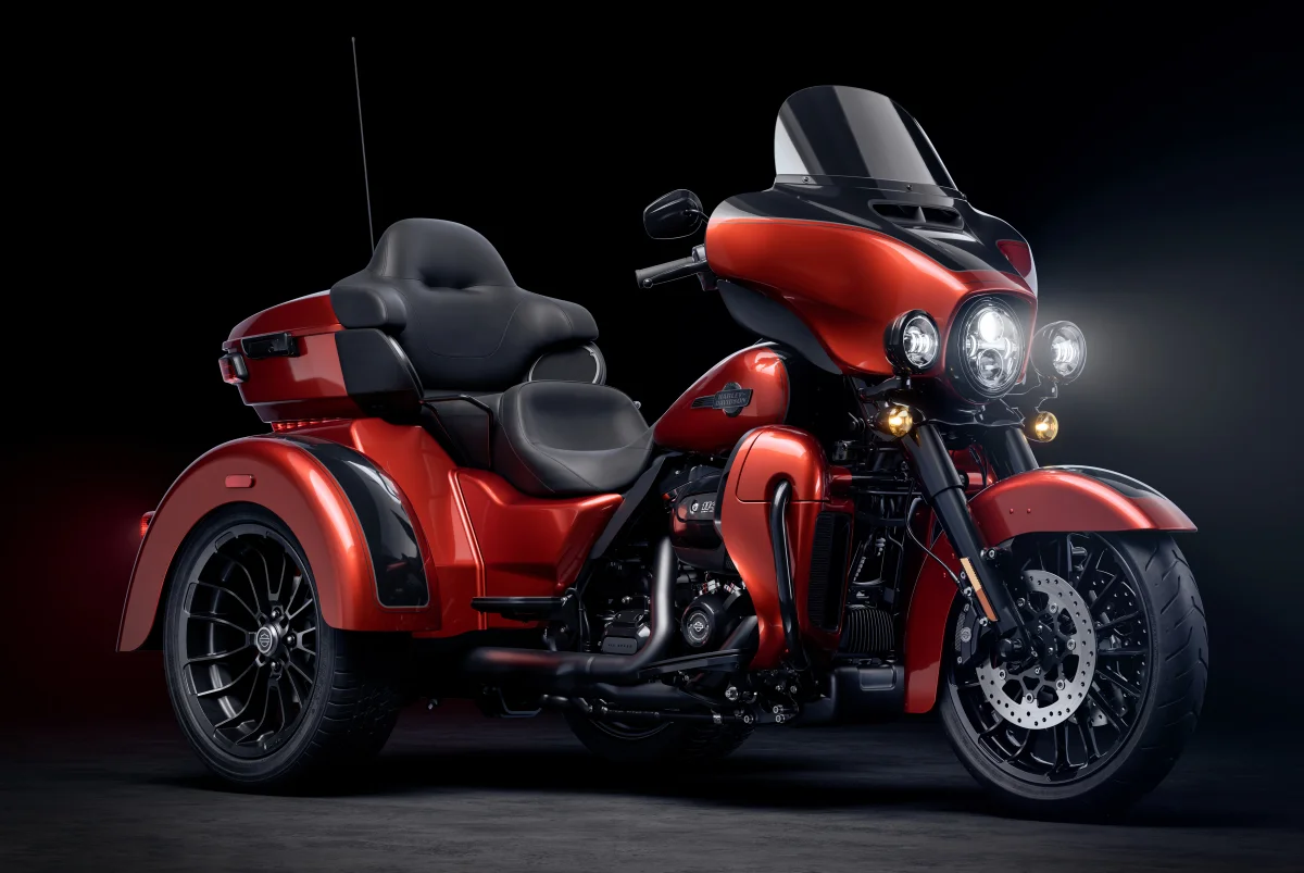 A bright red Harley-Davidson Tri Glide Ultra in studio lighting