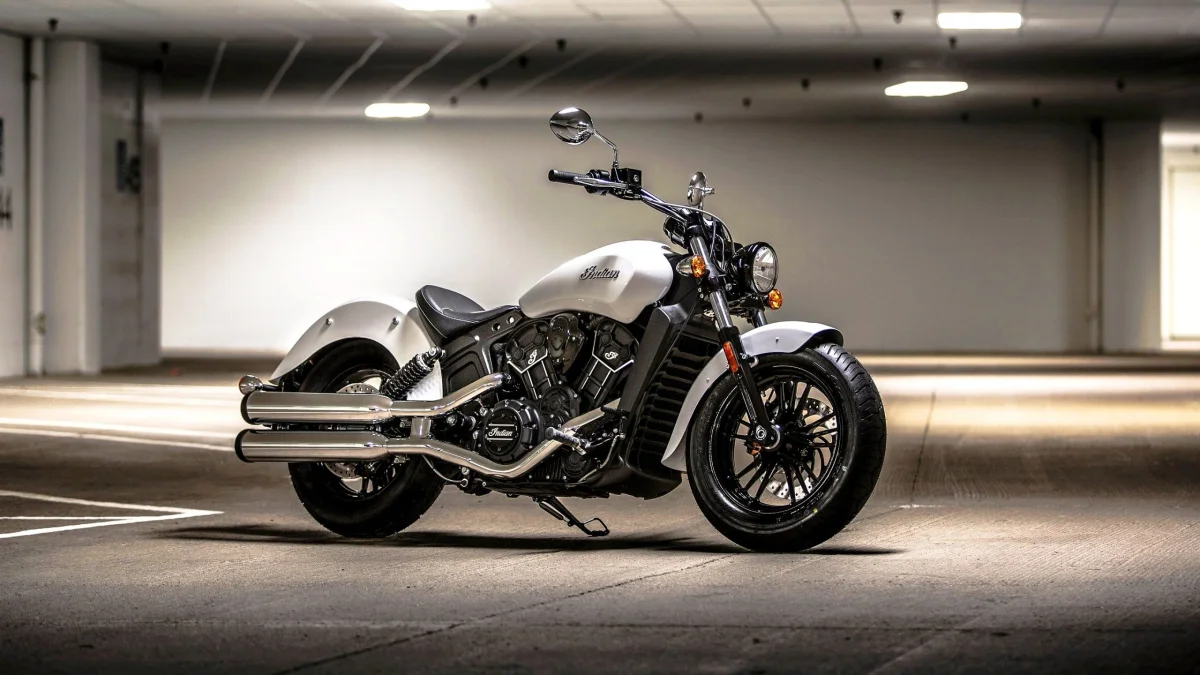 A white Indian Scout in the light of the underground parking garage's lamps