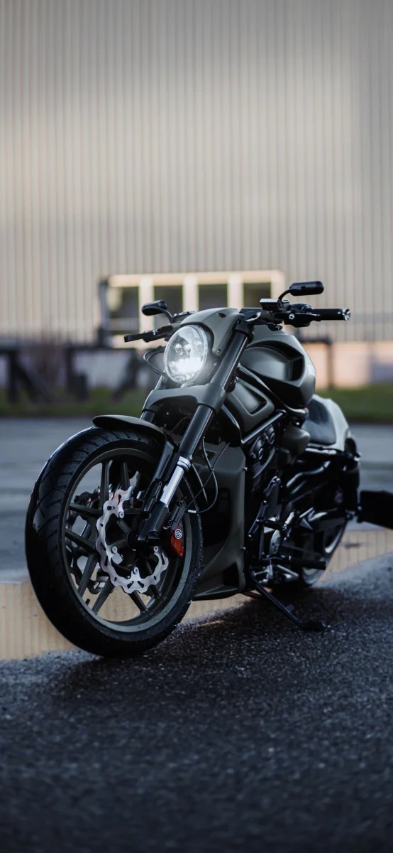 A matte-finish Harley-Davidson Sportster S against the backdrop of an industrial building