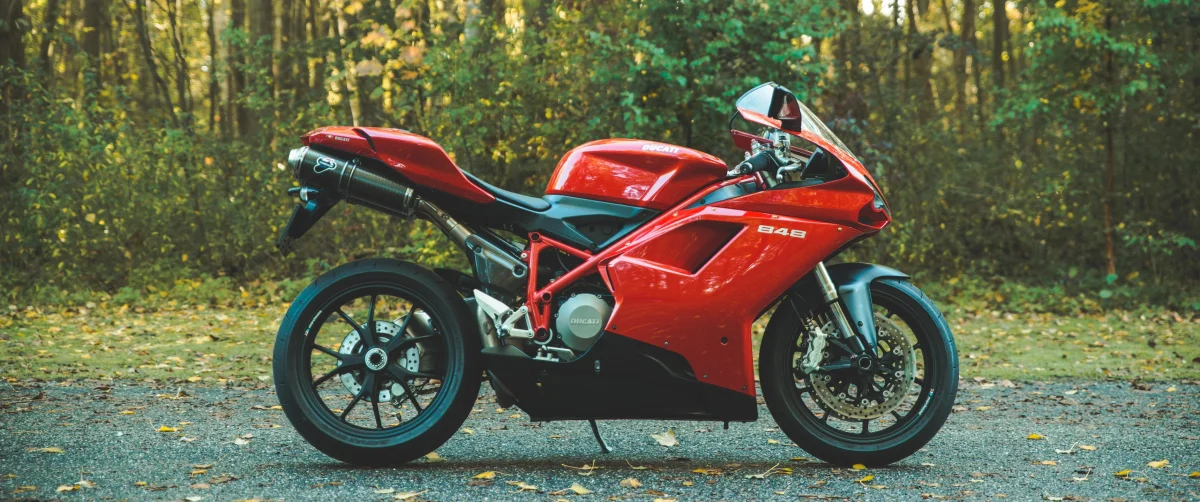 a red ducati 848 against the backdrop of an autumn forest, ducati 848, autumn, autumns, discs, wheels, ducati, forest, forests, leaves, foliage, leafage, frondage, motorcycles, bikes, roads, highways, motorways, avenues, driveways, passageways, sport bikes, technology