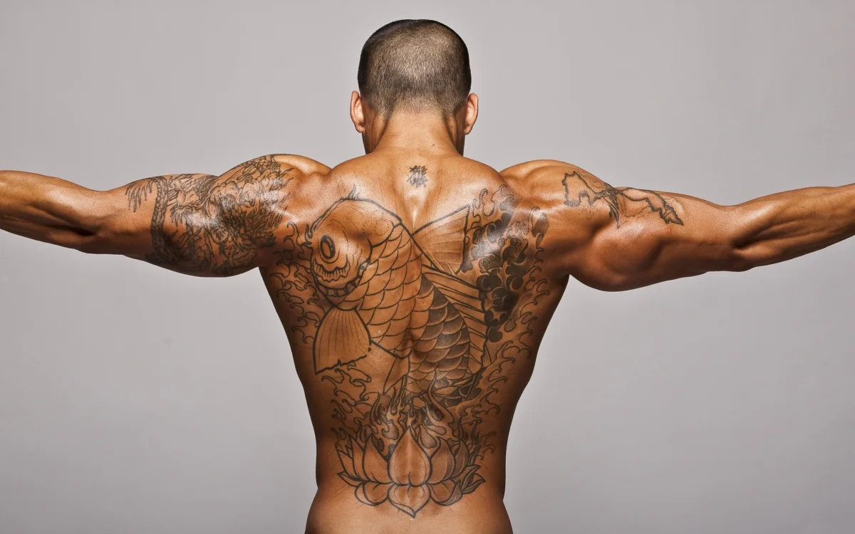 A man's torso with a koi tattoo