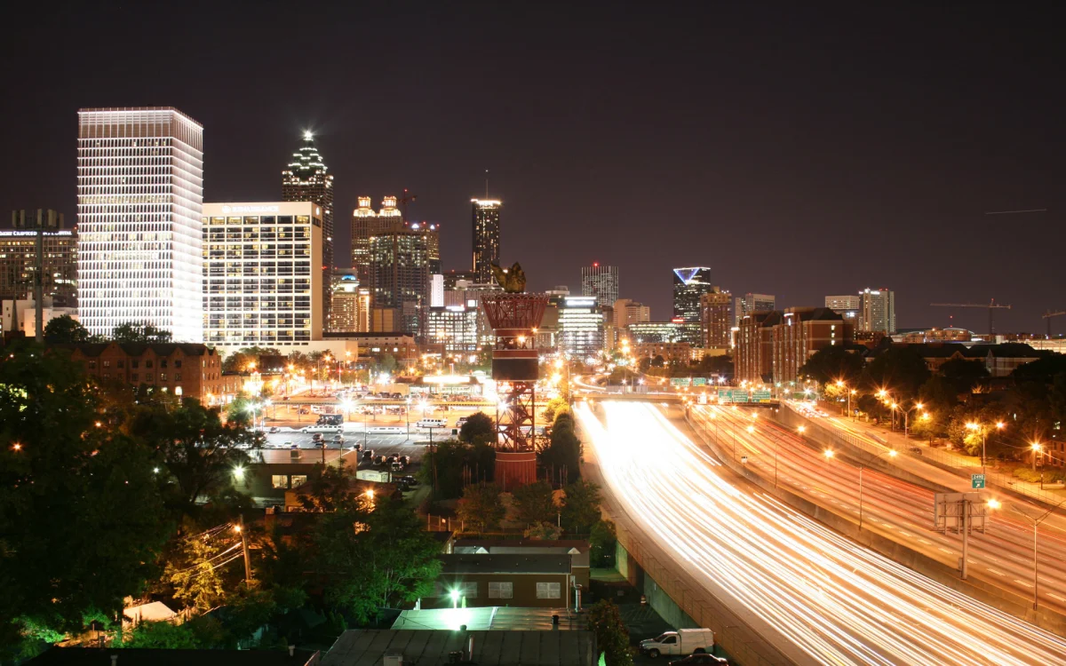 Light trails from cars against the backdrop of Atlanta's skyscrapers