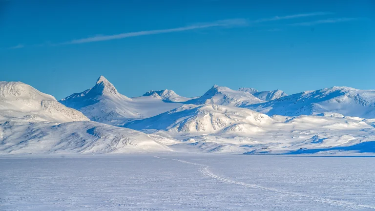 The snow-capped peaks of the Hardangervidda Plateau