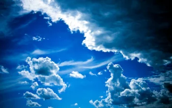 Contrasting cumulus clouds against a bright blue sky