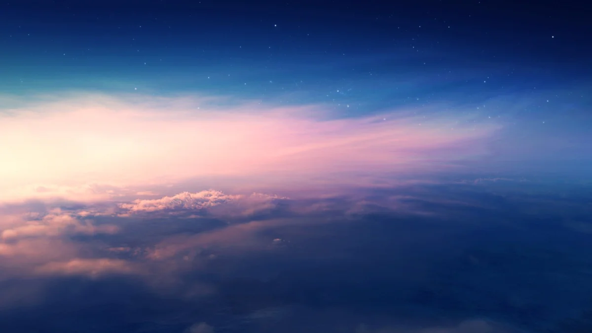 A pink dawn over a layer of feathery clouds