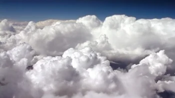 Snow-white cumulus clouds in the blue sky
