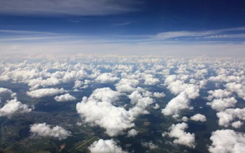 White cumulus clouds above the ground