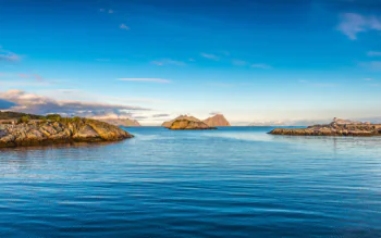 The calm waters and rocky shores of the Lofoten Islands in Norway