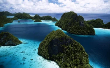 Green, rocky islands in the azure waters of the Raja Ampat Archipelago