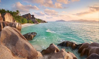 Golden rays of sunlight on the coast of La Digue Island